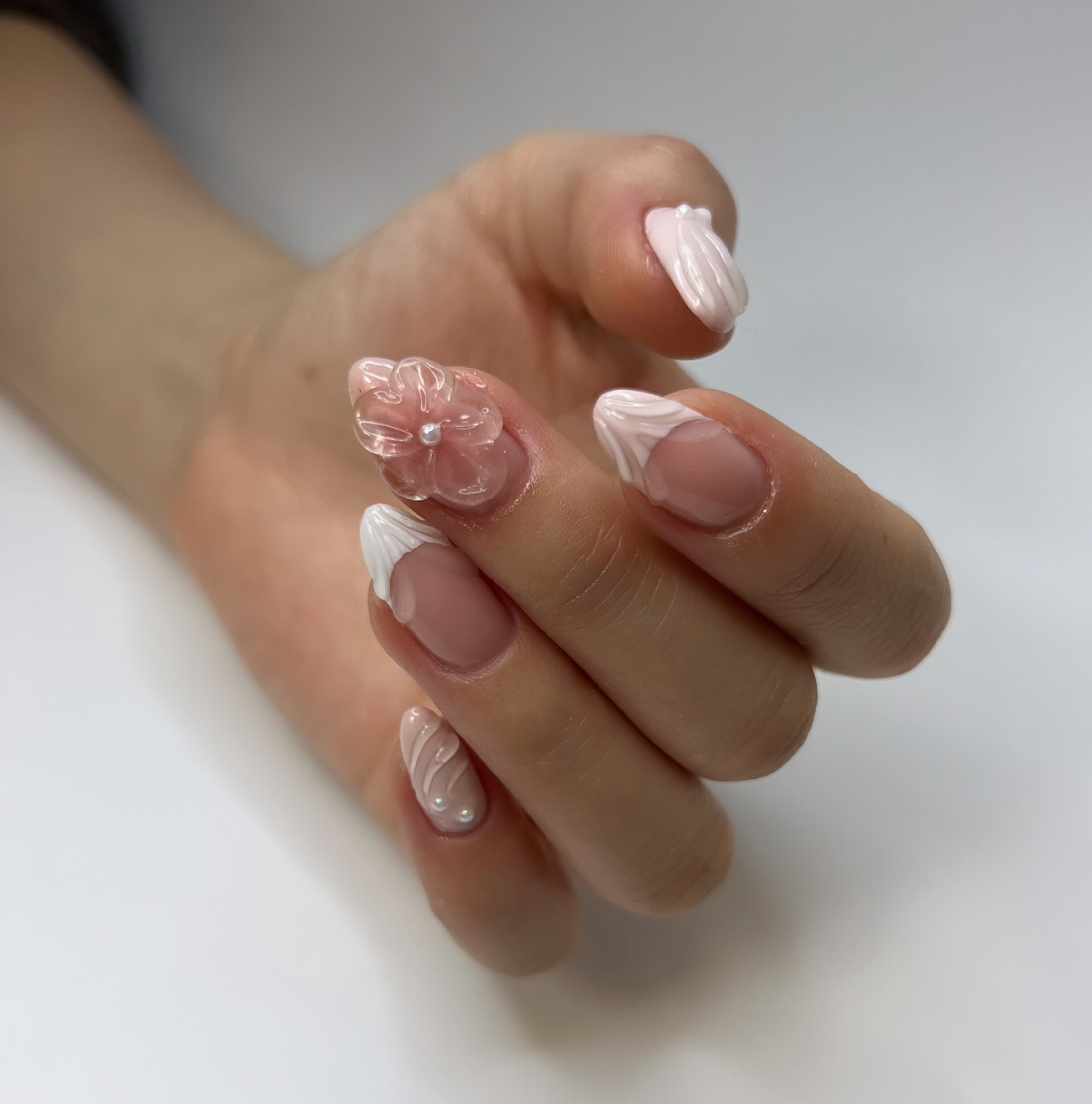 3D white and pink nail art with waves and flowers